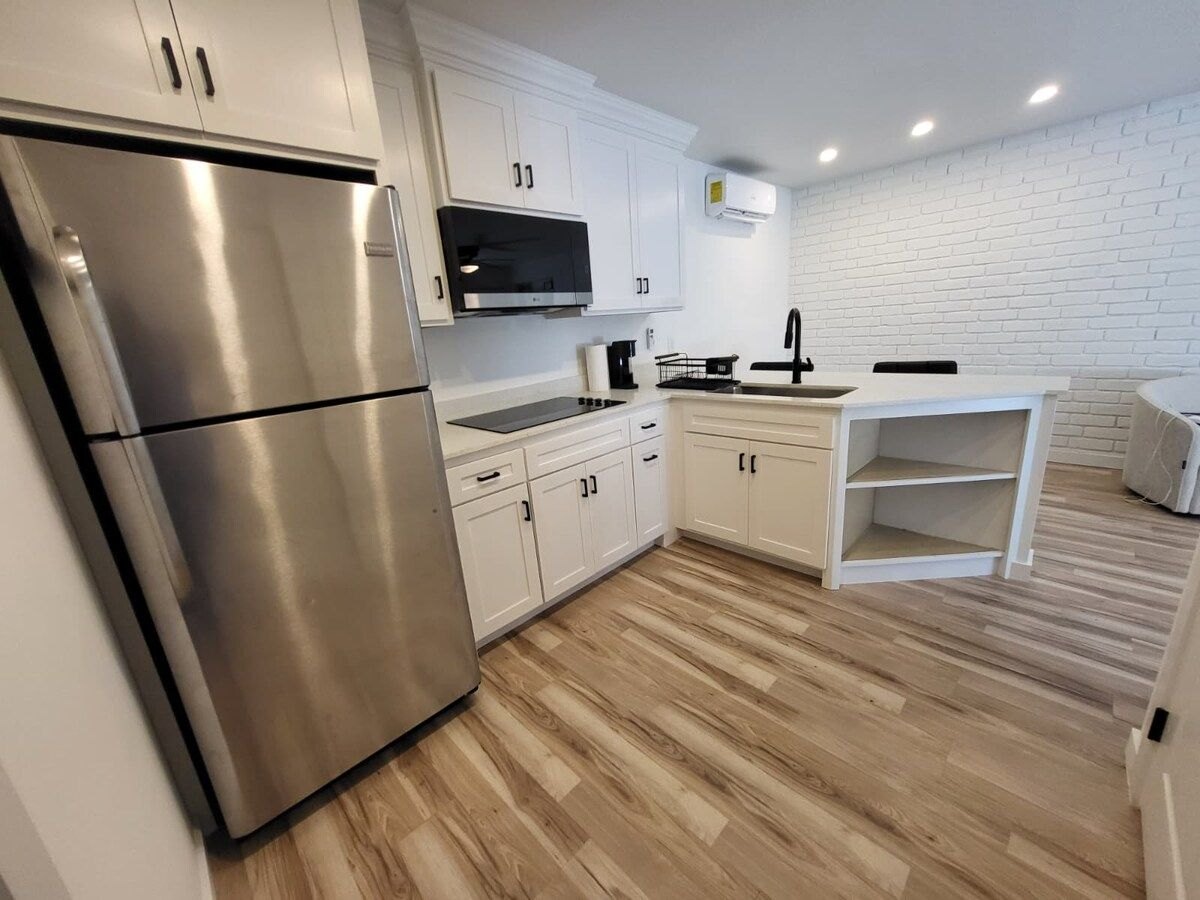 McFadden Pad kitchen with white cabinetry and stainless steel appliances